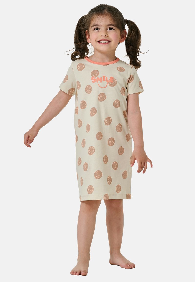 Vestito beige a maniche corte con pois marroni e un accento corallo. La parte frontale presenta il testo "SORRIDI" con una grafica di una faccina sorridente.