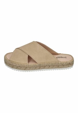 Beige slip-on sandal with crossover straps, suede material, jute espadrille sole, and textured white rubber bottom.