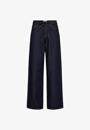 Mørkeblå vidde bukser i denim med snøre i taljen, store sidelommer og kontrasterende syninger. Glat tekstur, lige skæring.