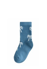 Calcetín azul con patrones de palmeras blancas, puño acanalado y zonas lisas en la punta y el talón.