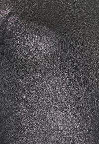 Metallic fabric in dark gray with a fine, shimmering texture. Surface shows a reflective, sparkling finish with a slightly crinkled pattern.