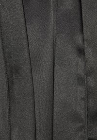 Black pleated fabric with a smooth texture, featuring a subtle sheen. Patterns are minimal, with vertical pleats running throughout.