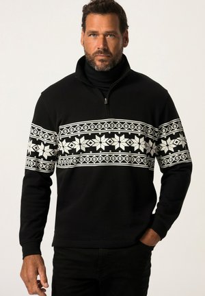 Suéter negro con cuello con cremallera que presenta un patrón de copos de nieve blancos en el pecho. La tela tiene un acabado texturizado y mangas largas.