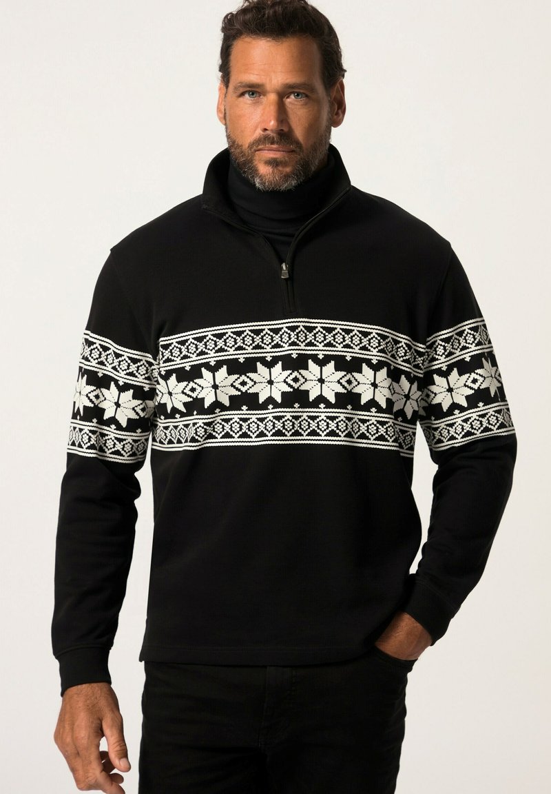 Suéter negro con cuello con cremallera que presenta un patrón de copos de nieve blancos en el pecho. La tela tiene un acabado texturizado y mangas largas.