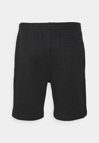 Svarta bomullsshorts med elastisk midja, med en bakficka och nedvikta fållar för en avslappnad passform. Slät textur och avslappnad design.
