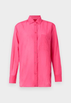 Camicia a maniche lunghe con bottoni di un vivace colore rosa, realizzata in materiale leggero. Presenta una tasca sul petto e una finitura in tessuto testurizzato.
