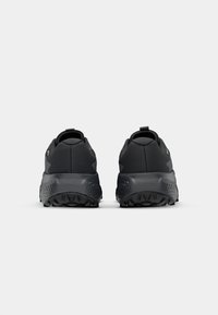Pair of black athletic shoes with textured thick soles shown from the back on a plain white background.