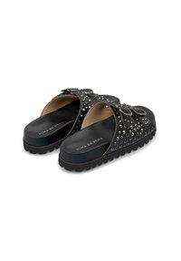 Black slip-on sandals with studded upper, adjustable buckle, and textured outsole. Features a smooth interior lining and logo detail.