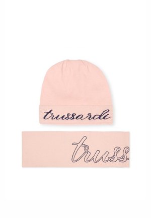 Roze gebreide beanie en bijpassende hoofdband, met op de muts en de band in marineblauw geborduurde tekst "trussardi" en "truss". Zacht, rekbaar materiaal.