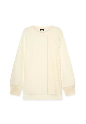 Sudadera crema con detalle de punto de cable en un lado, puños acanalados y cuello redondo. Textura suave y corte relajado.