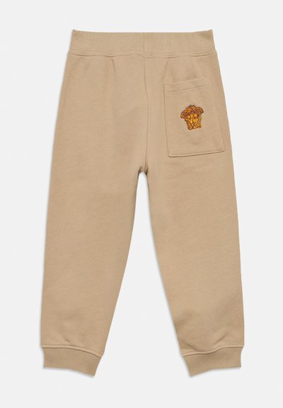 Μπεζ φόρμες με ελαστική ζώνη μέσης, ριμπ μανσέτες και πίσω τσέπη με καφέ και πορτοκαλί κεντητό σχέδιο. Μαλακή υφή.