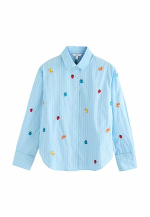Chemise boutonnée bleu clair à rayures blanches, décorée de petits fruits brodés dont des fraises, des myrtilles et des tranches d’orange.