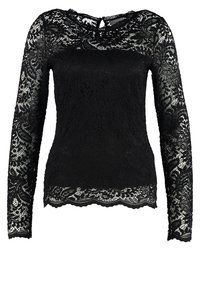 Haut noir à manches longues en dentelle avec un motif fleuri, doté d'un décolleté rond et d'un ourlet festonné. Ouverture en forme de clé à l'arrière.