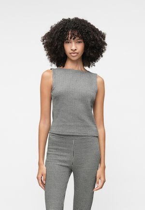 Black and white houndstooth patterned sleeveless top with a straight neckline, paired with matching fitted pants. Smooth, stretch fabric.