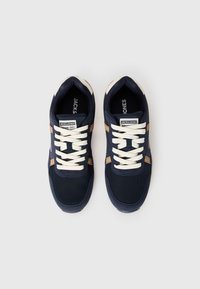 Navy blue athletic shoes with mesh and synthetic material, cream laces, and brown accents. Features logo and textured sole. Top view.