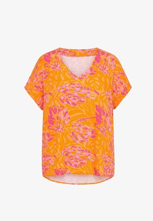 Bluzka z krótkim rękawem i dekoltem w serek, z jasno pomarańczową bazą i dużym różowym tropikalnym nadrukiem liści, luźny krój z lekko zakrzywionym dołem.