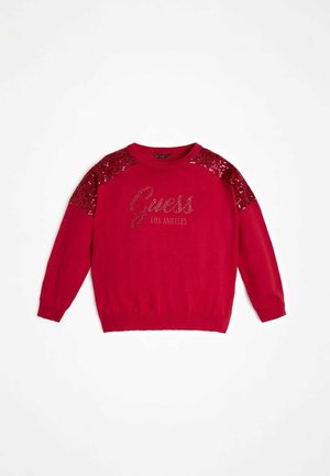 Rød sweater med lange ærmer, rund halsudskæring, skulderdetaljer med pailletter og "Guess Los Angeles"-logo i rhinsten på forsiden.