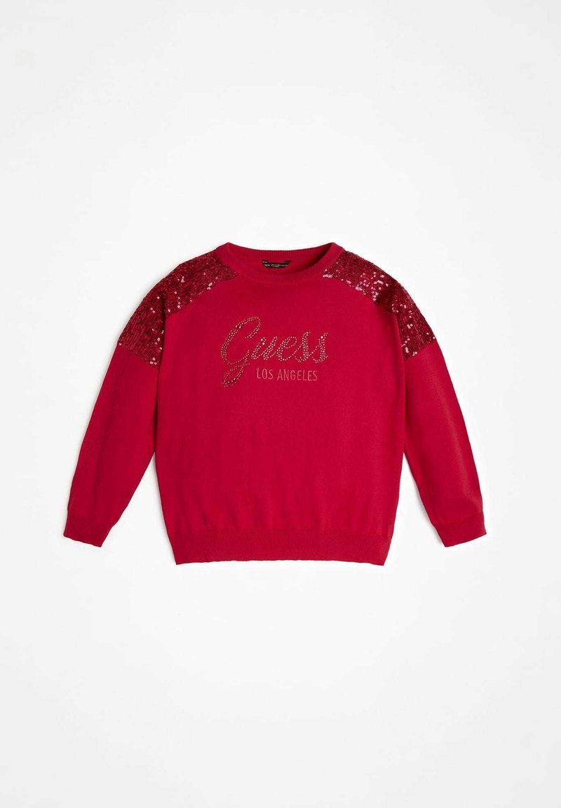 Pull rouge à manches longues, col rond, accents à paillettes sur les épaules, et logo "Guess Los Angeles" en strass sur le devant.