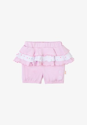 Pink shorts with a tiered ruffle overlay, featuring white fabric with colorful dots and a small embroidered giraffe on the leg.
