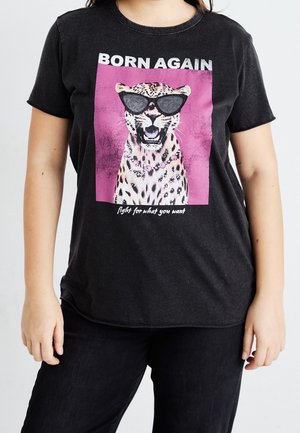 Lampart w okularach przeciwsłonecznych i naszyjniku na czarnej koszulce z napisem "BORN AGAIN" nad nim oraz "walcz o to, czego chcesz" poniżej.