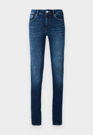 Mörk tvättade jeans med slim fit, fem fickor och knäppning. Har subtila blekningar och kontraststygn.