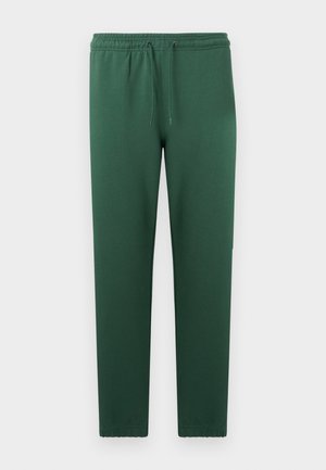 Green sweatpants made of soft fabric, featuring an elastic waistband with a drawstring, tapered legs, and no visible pockets or patterns.