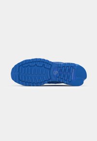 Blue athletic shoe sole with a textured pattern, featuring raised sections for traction and cushioning. Rubber material for durability.
