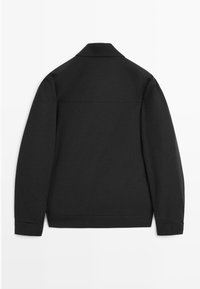 Black, long-sleeved shirt jacket with a smooth, matte texture and a structured collar. Features a simple design with no visible closures or embellishments.