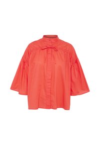 Blusa di cotone corallo con colletto alla cinese, chiusura frontale con bottoni e maniche a palloncino arricciate. Presenta un dettaglio di nodo frontale e una texture morbida e liscia.