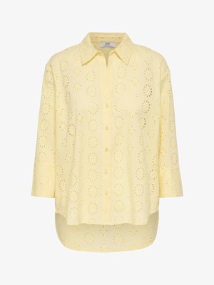 Light yellow button-up blouse with 3/4 sleeves and an eyelet floral pattern throughout the fabric.