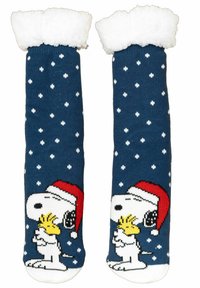 Calzini blu navy con motivo di fiocchi di neve bianchi, con un cartone animato di Snoopy in un cappello di Babbo Natale rosso che tiene Woodstock. Dettaglio del bordo peloso bianco.