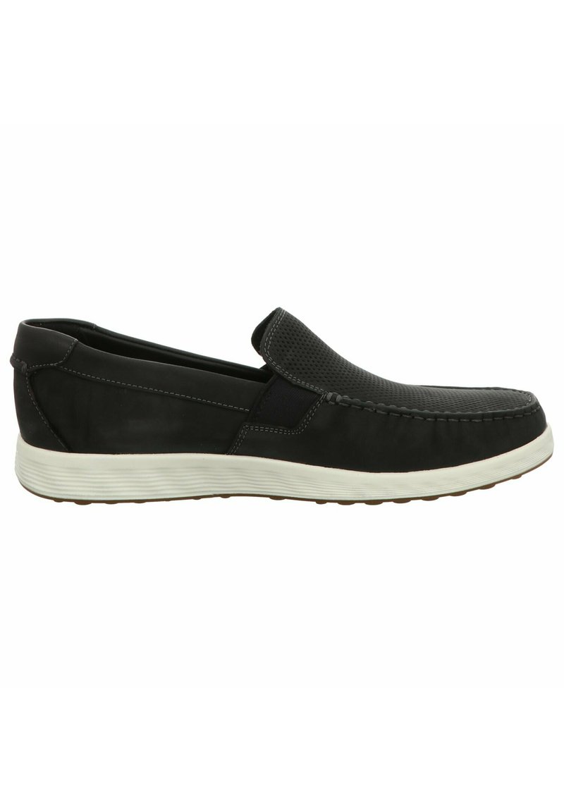 Scarpe slip-on nere con tomaia testurizzata che presenta dettagli in rete, suola in gomma bianca e cuciture lungo il bordo superiore.