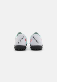 Footwear with a white and light blue upper, featuring pink accents. A black rubber sole with textured traction. "PHANTOM GT" text visible.