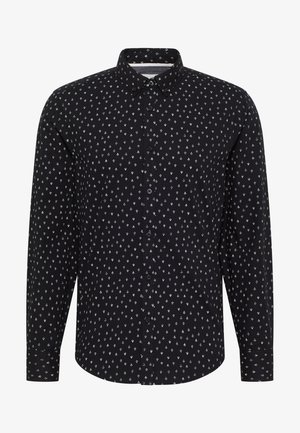 Camisa negra de manga larga con pequeño patrón geométrico blanco, cuello puntiagudo y puños abotonados.