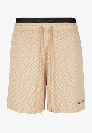 Krémszínű hálós rövidnadrág fekete elasztikus derékpánttal, amely húzózsinórral és oldalsó cipzáras zsebekkel rendelkezik. A bal alsó szegélyen logós felirat található.