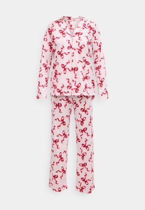 Matching pajama set in light pink fabric with red ribbon patterns, featuring a long-sleeve top and loose-fitting pants. Classic collar design.