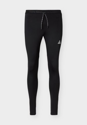 Schwarze, enganliegende Sportleggings mit Kordelzug in der Taille und weißem ACG-Dreiecklogo am Oberschenkel.