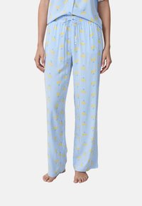Pantaloni da pigiama in cotone leggero, blu con strisce bianche, decorati con motivi a fiori gialli. Vita elasticizzata con cordoncino. Vestibilità dritta.