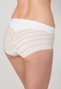 White underwear featuring a smooth waistband, sheer fabric with horizontal nude stripes, offering a minimalist and comfortable design.