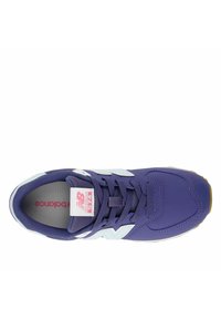 Purple New Balance 574 sneaker with white "N" logo, purple laces, pink and white label on tongue, viewed from above.