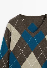 Pull marron col en V avec motif losanges argyle bleu, beige et marron foncé et détails de coutures blanches.