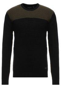 Maglione lavorato a maglia con un corpo nero e uno yoke testurizzato di colore verde oliva. Collo rotondo, maniche lunghe e un discreto etichetta del marchio sul lato.