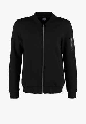 Black bomber jacket made of smooth fabric, featuring a front zipper, two side pockets, and a zippered sleeve pocket. Ribbed cuffs and hem.