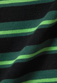 Black and green striped fabric with varying widths of stripes. Texture is soft and knitted, showcasing a blend of dark and vibrant shades.