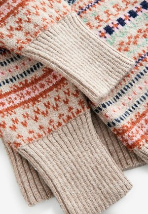Beżowy sweter dzianinowy z pomarańczowymi i niebieskimi wzorami. Posiada ściągacze, miękką fakturę i geometryczne wzory na całej powierzchni.