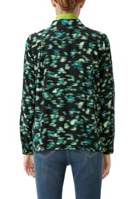 Black shirt featuring an abstract green and blue pattern, with a green collar. The fabric appears lightweight and slightly glossy.