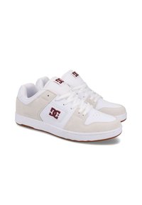 White athletic shoes with beige suede accents, featuring a logo on the side, lace-up design, perforated toe for breathability, and rubber outsole.