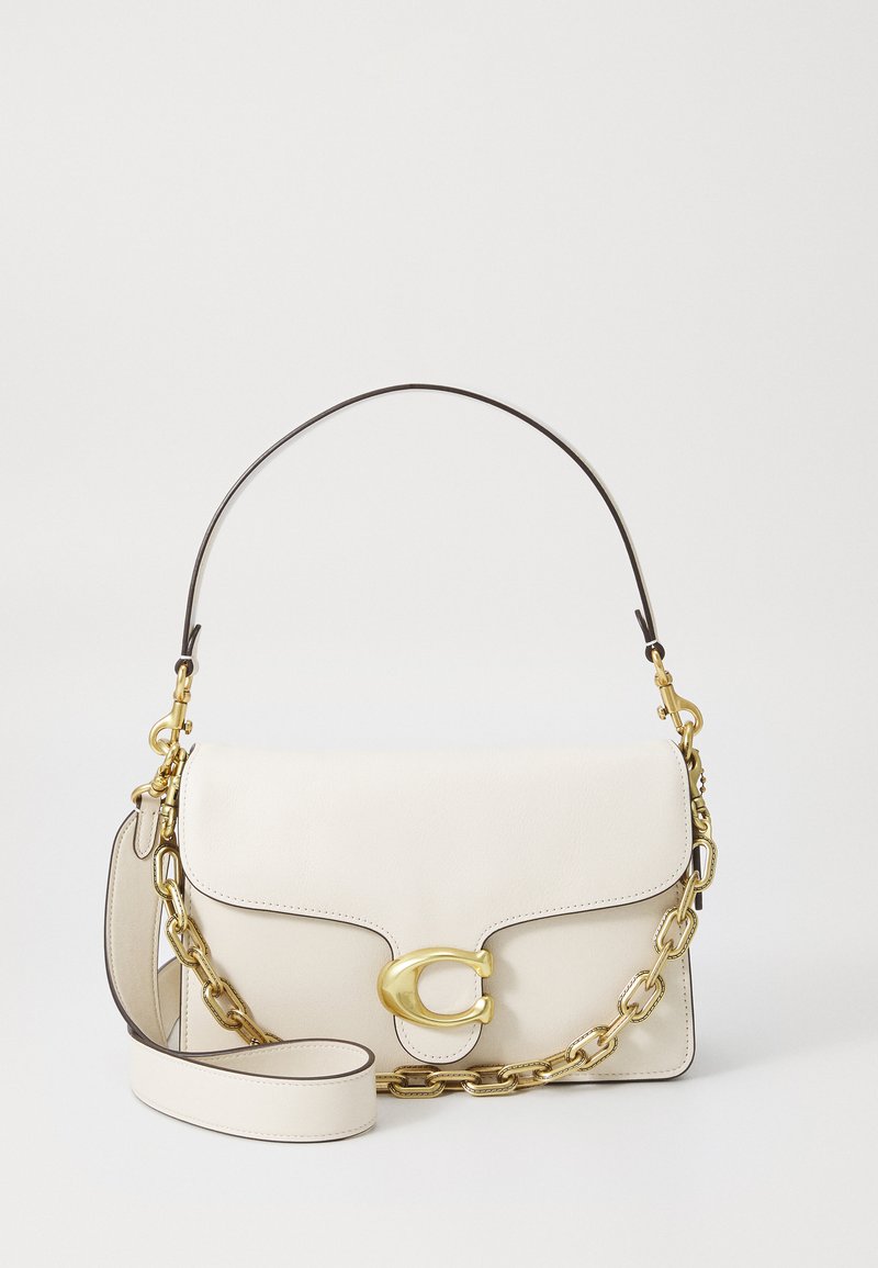 White leather handbag with a gold-tone clasp, a chain strap, and a detachable shoulder strap; features curved lines and contrast stitching.