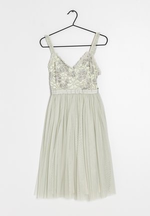 Lichtgroene jurk met een V-hals, versierde lijfje met bloemenpatronen en een gelaagde tule rok. Inclusief hangtag.