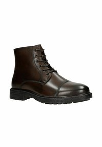 Stivali ankle in pelle marrone con finitura liscia, punta tonda, design con lacci, suola in gomma e delicati dettagli di cucitura lungo i lati.